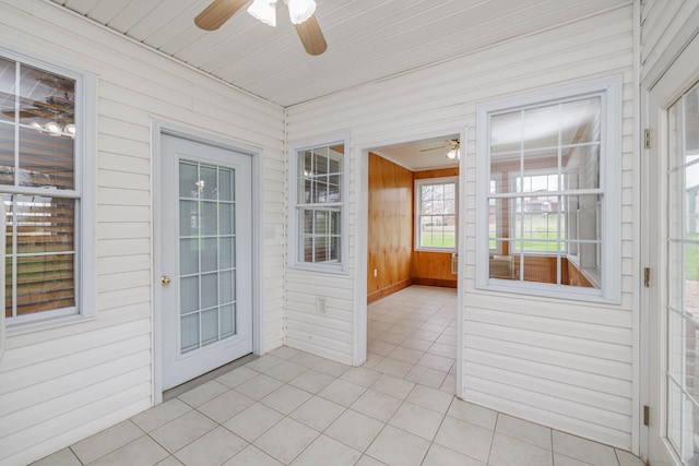 unfurnished sunroom with ceiling fan and wood ceiling