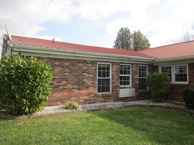 back of house with a lawn