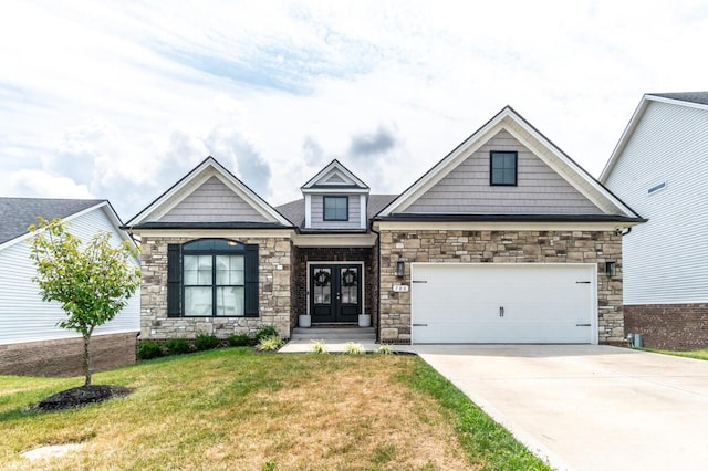 craftsman house featuring french doors, a garage, and a front lawn