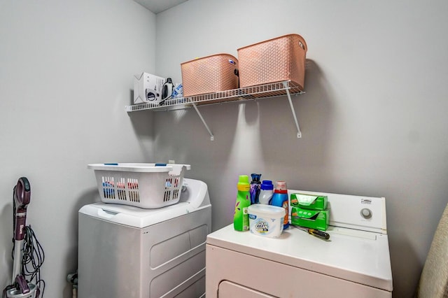 clothes washing area with separate washer and dryer