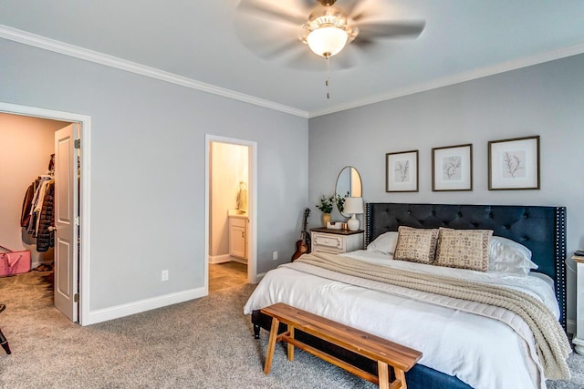 carpeted bedroom featuring a walk in closet, a closet, ceiling fan, and ornamental molding