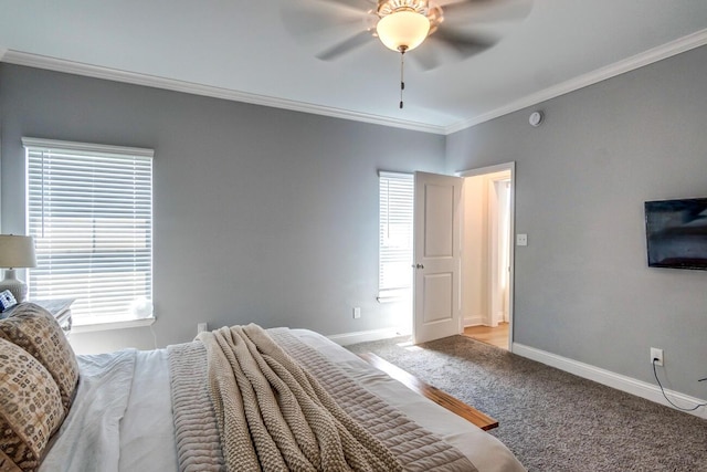 carpeted bedroom featuring ceiling fan and crown molding