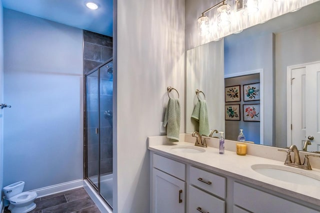 bathroom with tile patterned floors, vanity, and a shower with door