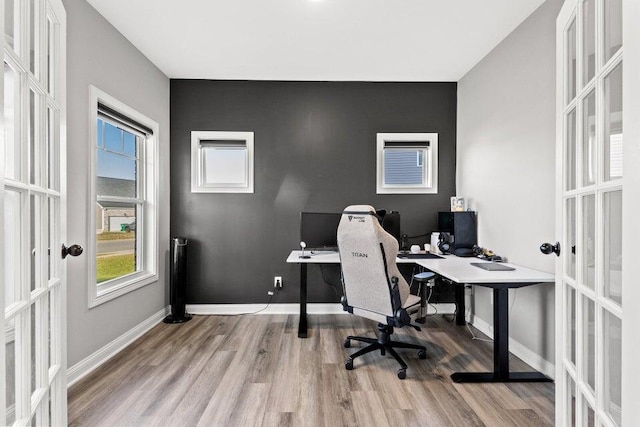 home office featuring french doors and light wood-type flooring