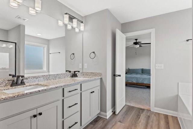 bathroom featuring hardwood / wood-style flooring, ceiling fan, and vanity