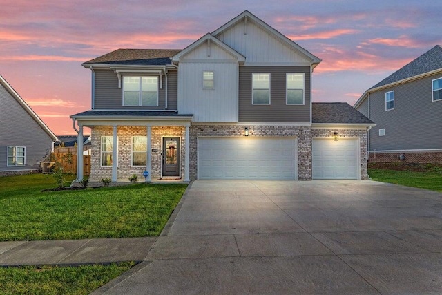 view of front of home with a garage and a lawn