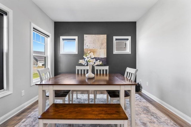 dining space with hardwood / wood-style floors