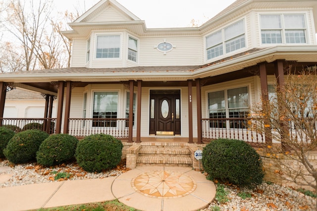 view of exterior entry with a porch