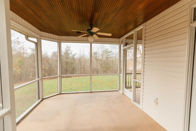 unfurnished sunroom featuring ceiling fan and wood ceiling