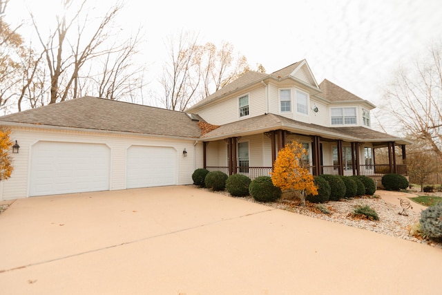 view of front of house with a porch and a garage