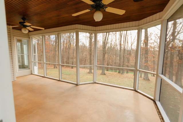 unfurnished sunroom with ceiling fan and wood ceiling