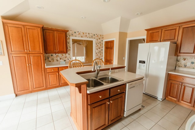 kitchen with a center island with sink, light tile patterned floors, white appliances, and sink