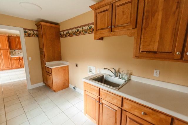 kitchen featuring light tile patterned floors and sink