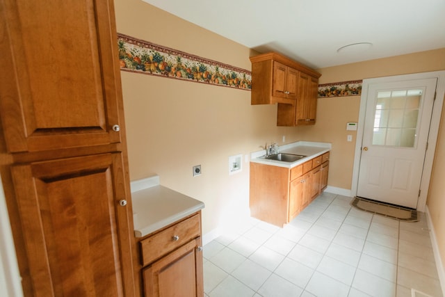 kitchen featuring light tile patterned floors and sink