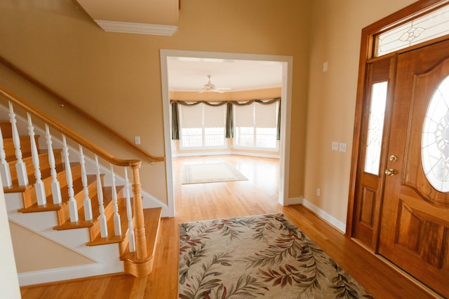 foyer entrance with ceiling fan and hardwood / wood-style floors