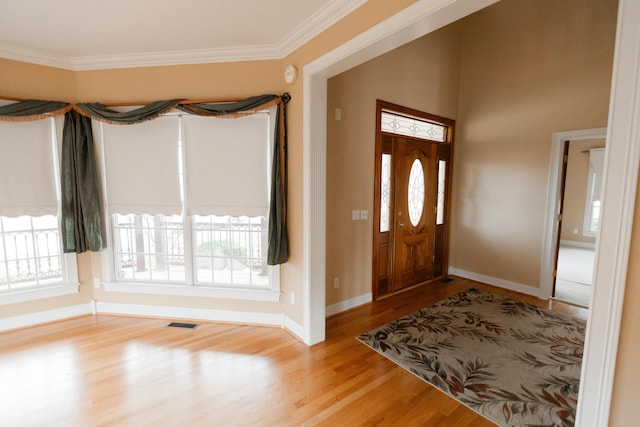 entryway featuring crown molding and wood-type flooring