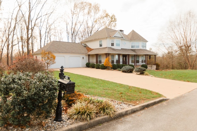 view of front of home featuring a porch, a garage, and a front lawn