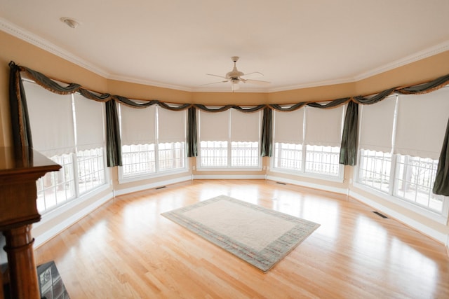 unfurnished sunroom with ceiling fan