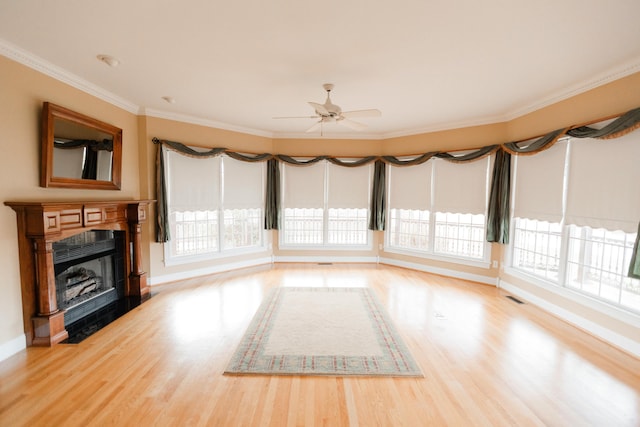 interior space with hardwood / wood-style flooring, plenty of natural light, and crown molding