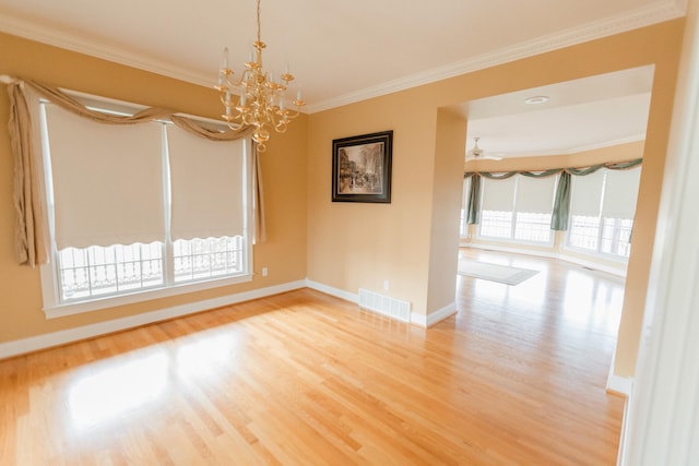 unfurnished room featuring ceiling fan with notable chandelier, light hardwood / wood-style floors, and crown molding