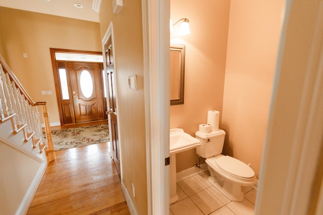 bathroom featuring hardwood / wood-style flooring and toilet