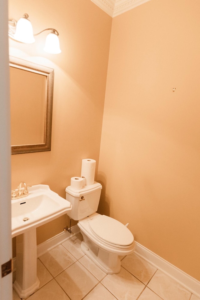 bathroom with tile patterned flooring, toilet, and ornamental molding