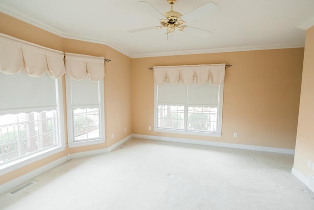 carpeted spare room with crown molding and ceiling fan