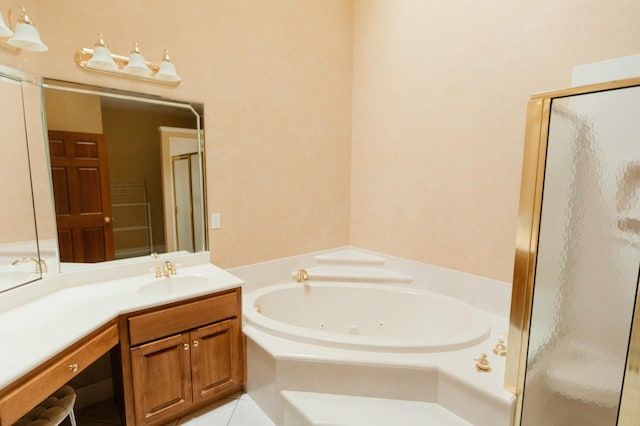 bathroom featuring plus walk in shower, tile patterned flooring, and vanity