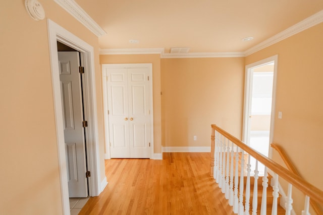 hallway featuring light hardwood / wood-style flooring and ornamental molding