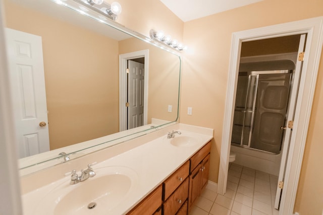 full bathroom with tile patterned floors, vanity, bath / shower combo with glass door, and toilet