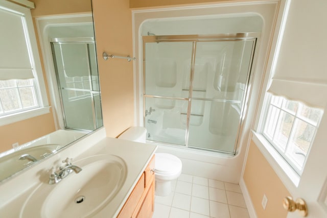 full bathroom featuring tile patterned flooring, vanity, toilet, and shower / bath combination with glass door