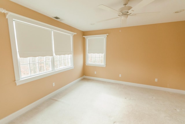 empty room with carpet flooring and ceiling fan