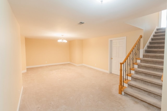 basement with carpet flooring and a notable chandelier