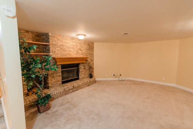 unfurnished living room with a fireplace and carpet