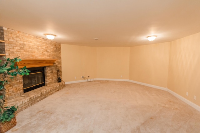 unfurnished living room with carpet and a fireplace