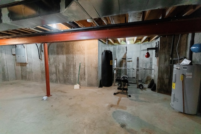 basement featuring electric panel and electric water heater