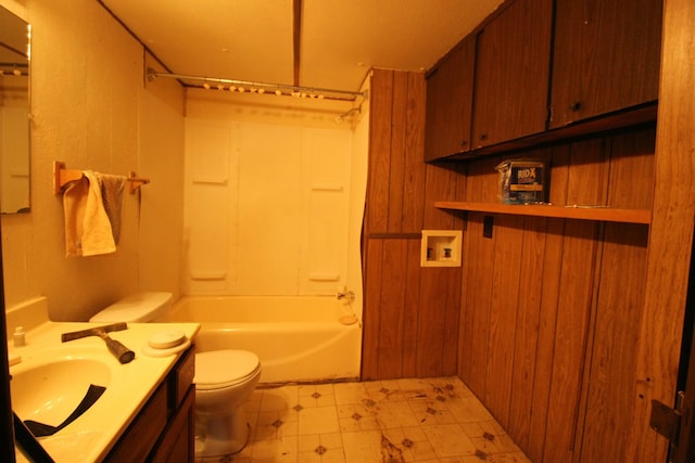 full bathroom featuring wood walls, shower / washtub combination, vanity, and toilet