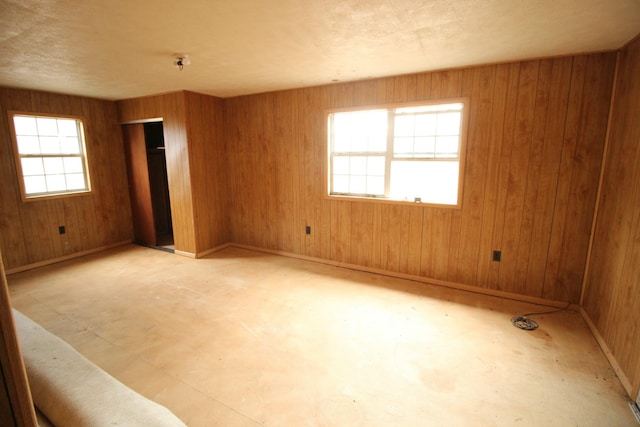 empty room featuring wood walls