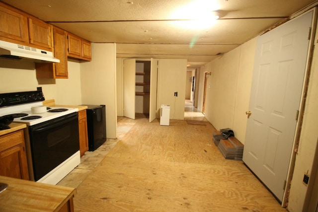 kitchen with electric range and black fridge