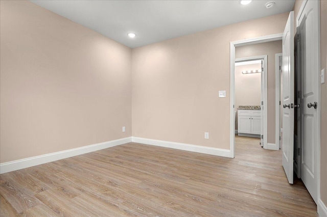 empty room with light hardwood / wood-style flooring