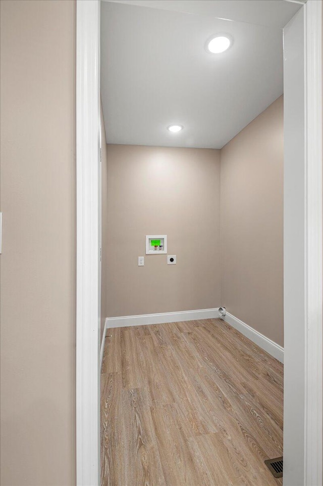 laundry room featuring washer hookup, hookup for an electric dryer, and light hardwood / wood-style flooring