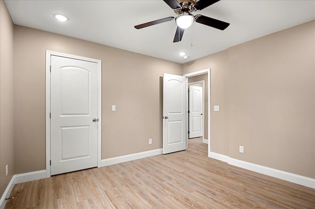 unfurnished bedroom featuring light wood-type flooring and ceiling fan