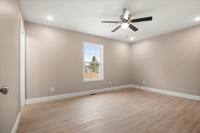 empty room featuring light hardwood / wood-style flooring and ceiling fan