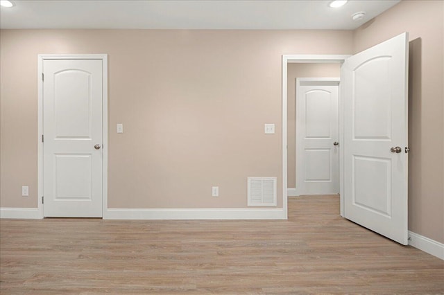 unfurnished room with light hardwood / wood-style floors