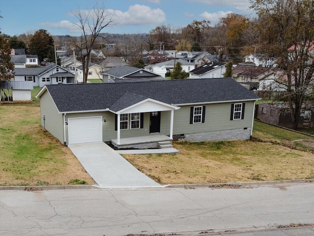 view of front of home featuring a garage, covered porch, and a front yard