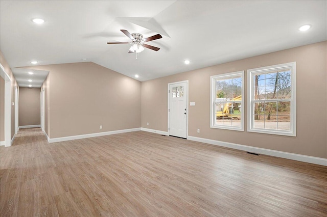 unfurnished living room with ceiling fan, light hardwood / wood-style floors, and lofted ceiling