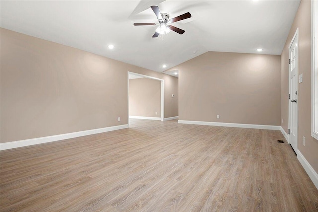 unfurnished room with light wood-type flooring, ceiling fan, and lofted ceiling