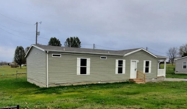 rear view of property with a lawn