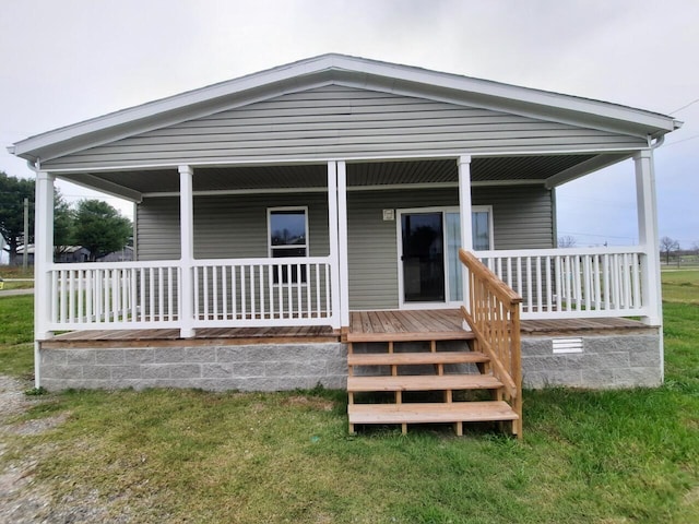 rear view of property with a yard and a porch