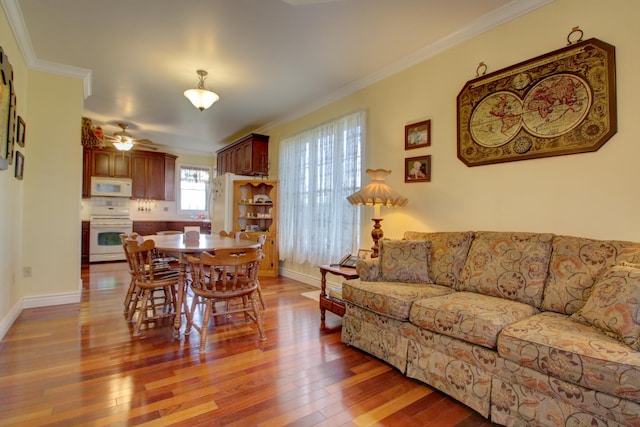 living room featuring crown molding, ceiling fan, and wood-type flooring